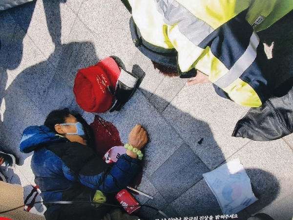 지난 2017년 3월10일 서울 종로 헌법재판소 입구에서 헌재의 탄핵선고에 저항하다가 공권력에 의해 쓰러진 한 애국열사. 바닥에는 피가 흐르고 있다.