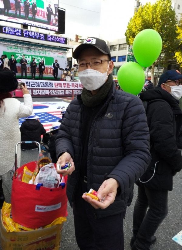 지난 해 3월1일 서울역 집회현장에서 사탕을 나누어주던 정조희 목사.